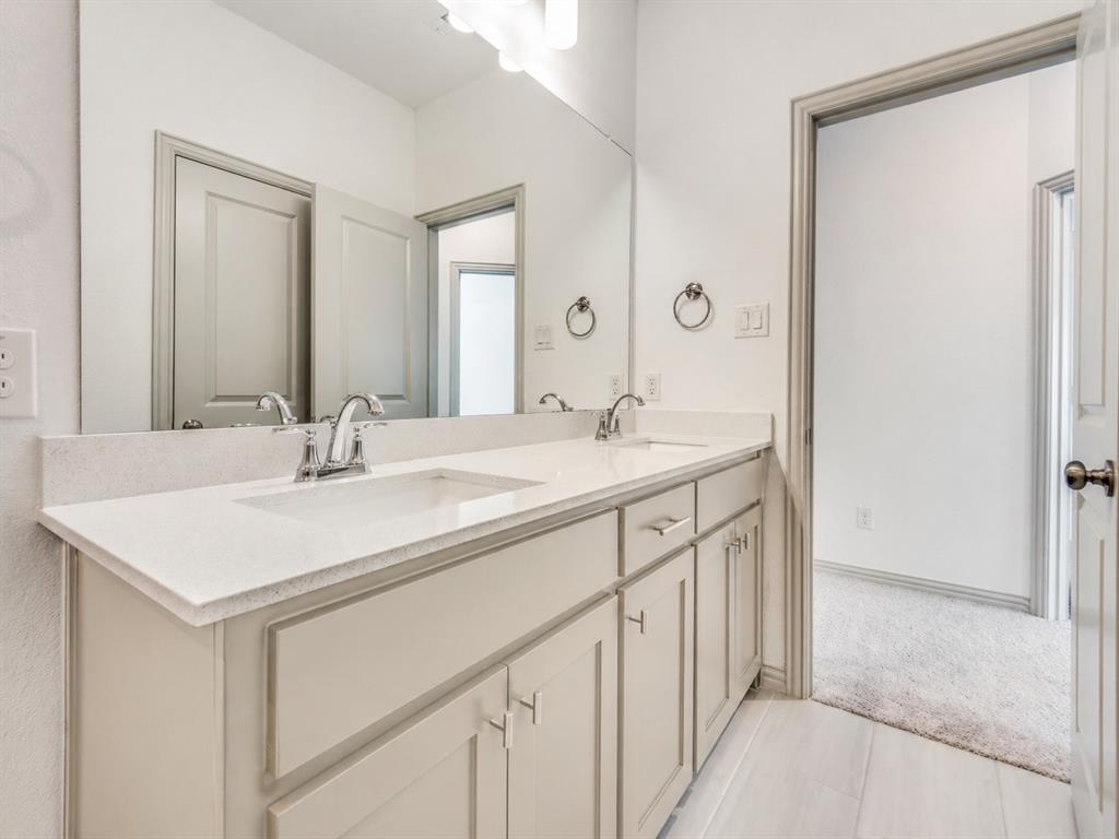 8913 Swallowtail Street Frisco, TX 75035 - Photo 18 of 38 a bathroom with a sink and a mirror