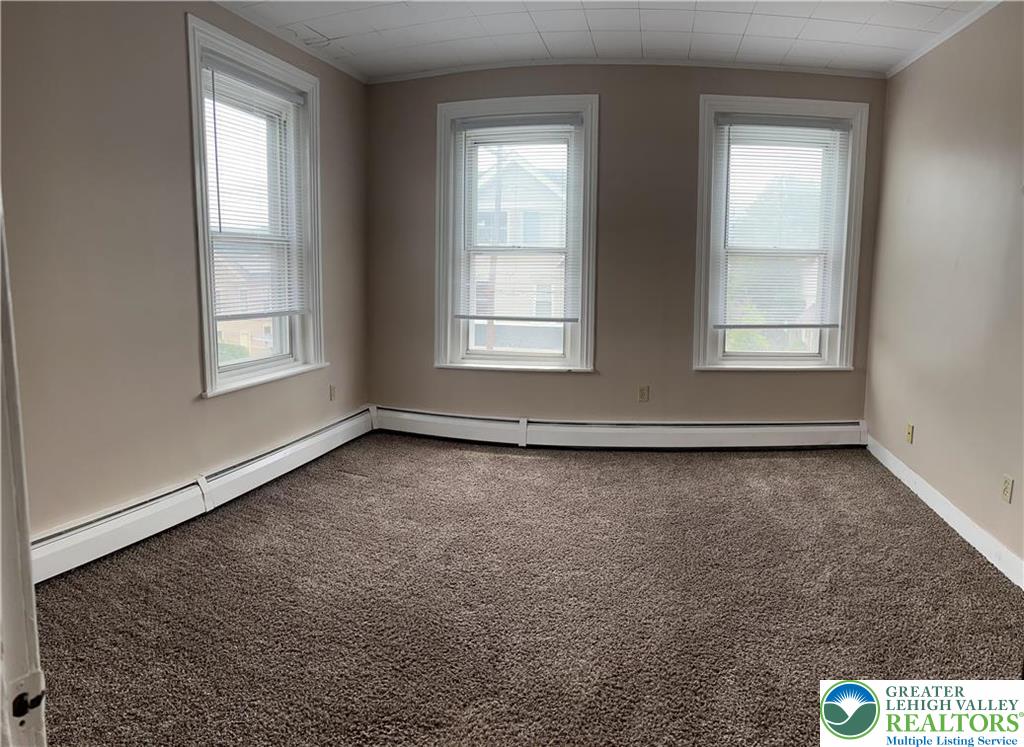 402 Prospect Avenue, Unit E2 Bethlehem, PA 18018 - Photo 11 of 11 an empty room with wooden floor and windows
