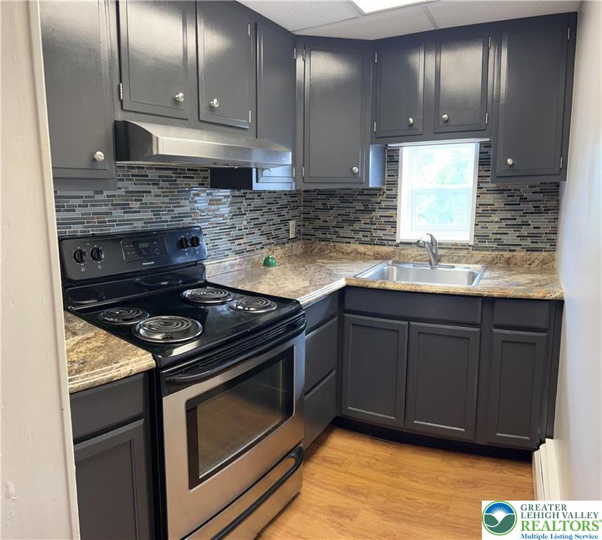 402 Prospect Avenue, Unit E2 Bethlehem, PA 18018 - Photo 2 of 11 a kitchen with granite countertop stainless steel appliances a sink stove and cabinets