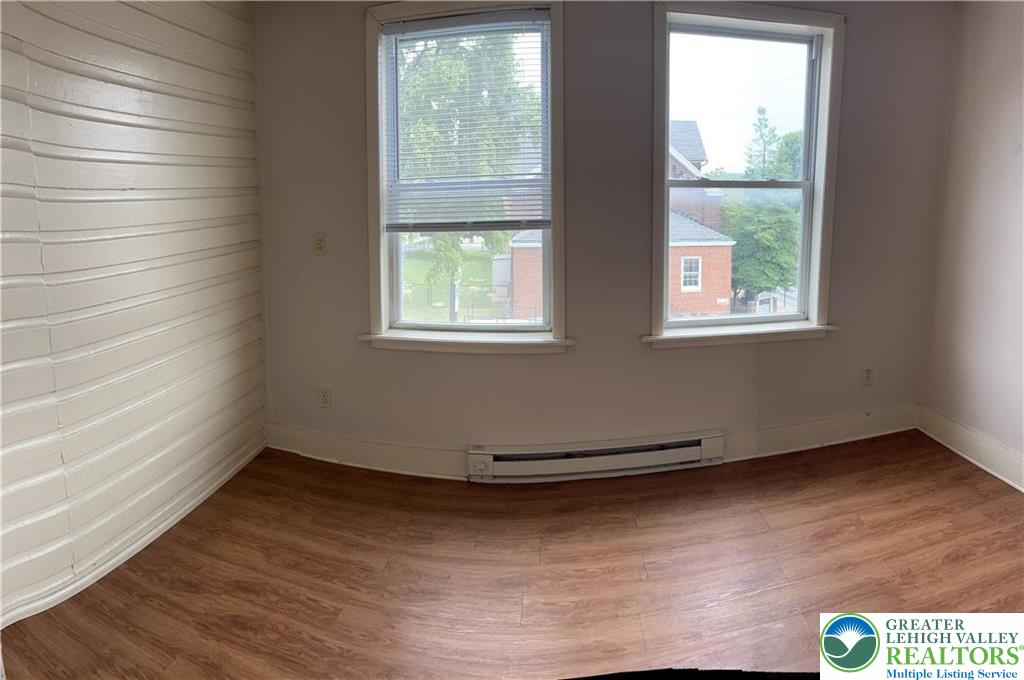402 Prospect Avenue, Unit E2 Bethlehem, PA 18018 - Photo 5 of 11 an empty room with wooden floor and windows