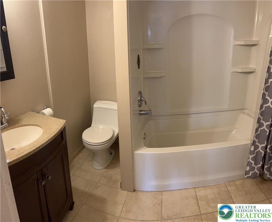 402 Prospect Avenue, Unit E2 Bethlehem, PA 18018 - Photo 7 of 11 a white bath tub sitting next to a white toilet