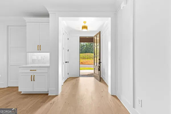 a large kitchen with granite countertop a large counter top a sink stainless steel appliances and cabinets