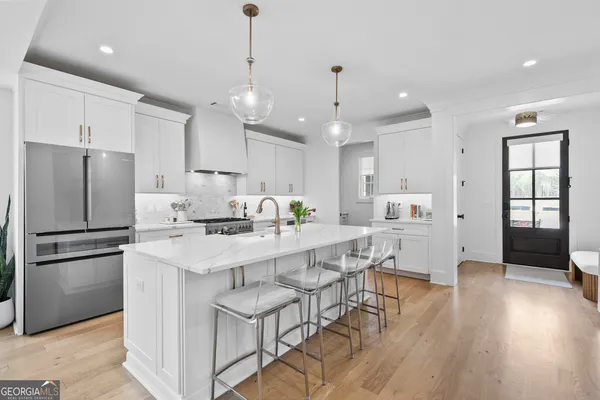 a kitchen with kitchen island stainless steel appliances a center island and windows