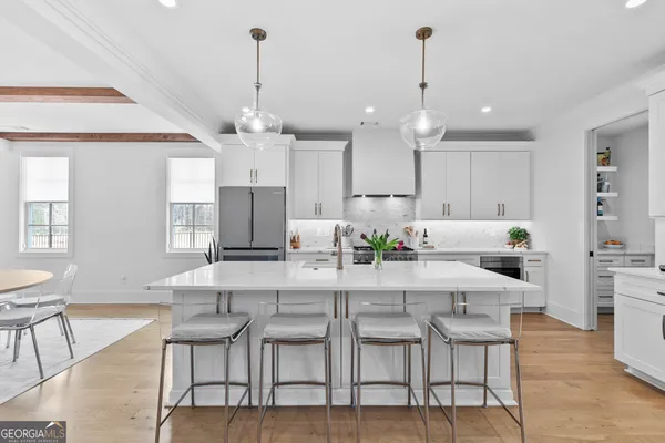a kitchen with a stove and wooden floor