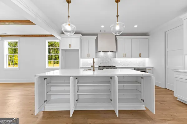 a kitchen with white cabinets sink and stainless steel appliances