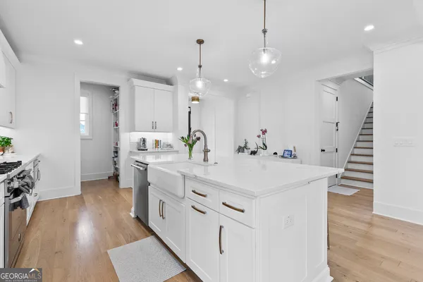 a kitchen with stainless steel appliances white cabinets and a stove