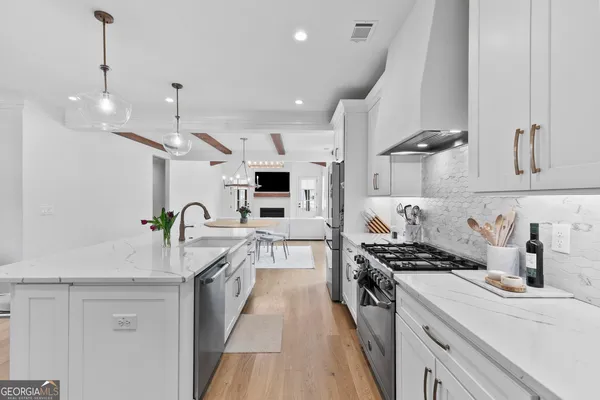 a kitchen with stainless steel appliances granite countertop a stove and a sink