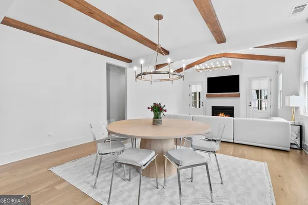 a kitchen with cabinets wooden floor and stainless steel appliances