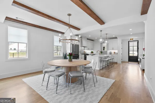 a view of a kitchen with wooden floor and a window