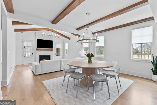 a view of empty room with fireplace and wooden floor