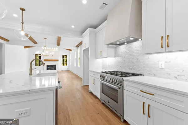 a view of an empty room with a window and fireplace