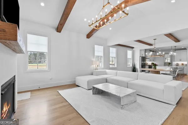 a view of empty room with wooden floor and windows