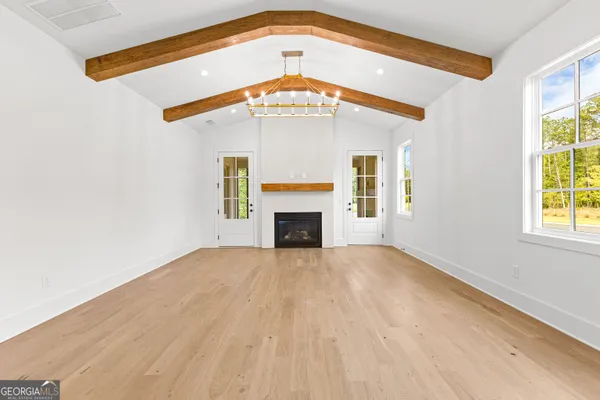a bathroom with double vanity sinks a large mirror and a bathtub