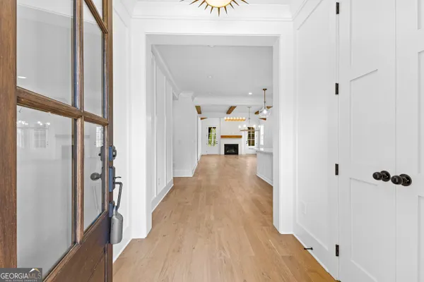 a view of a living room with furniture and wooden floor