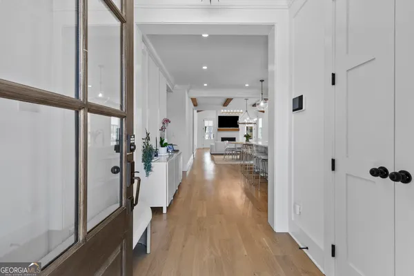 a view of an entryway with wooden floor
