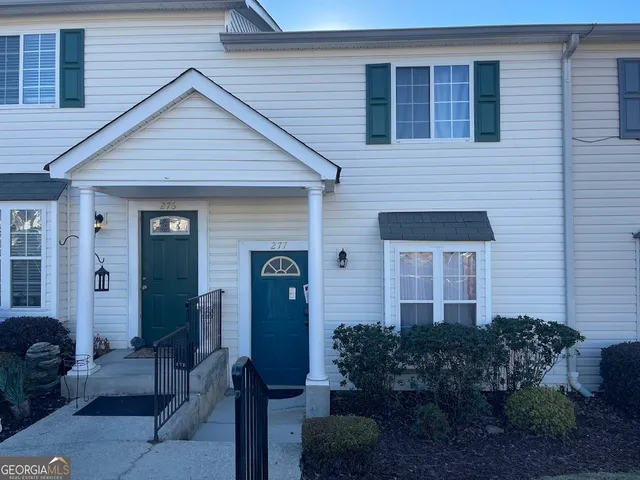 a front view of house with a garden