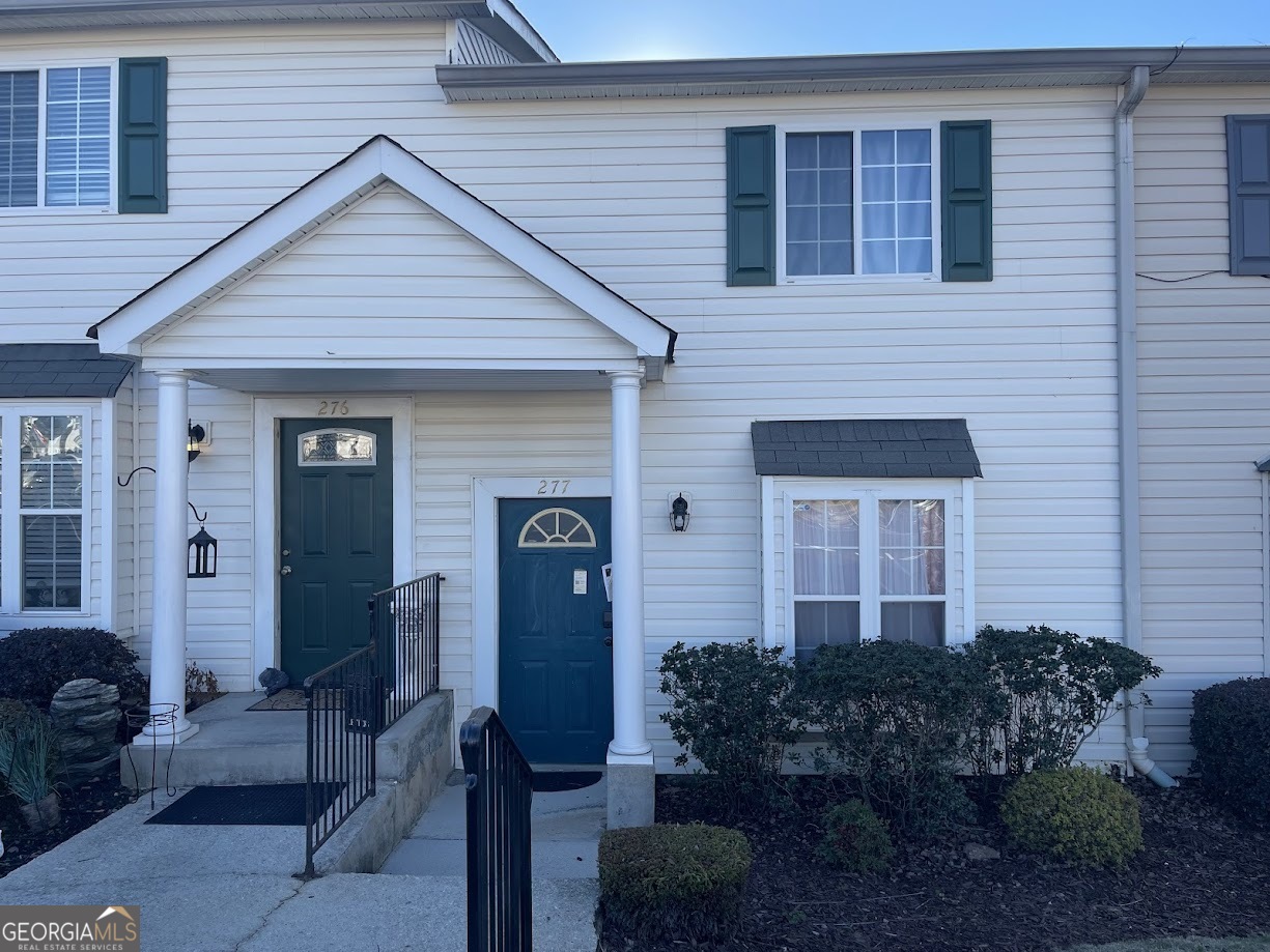 a front view of house with a garden