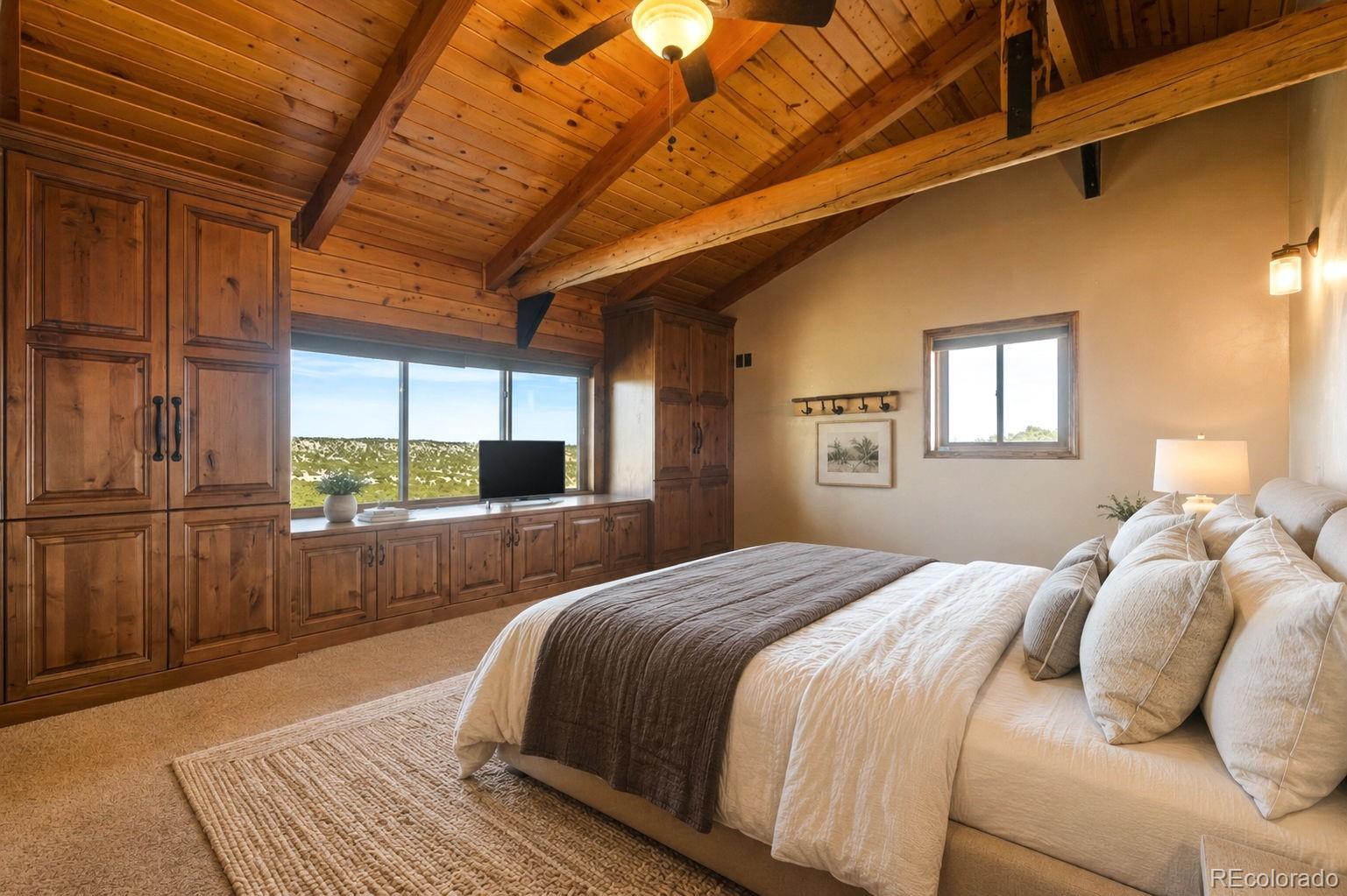 2925 Siloam Road Pueblo, CO 81005 - Photo 15 of 44 a bedroom with a bed wooden floor and window