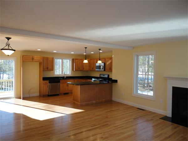 Lot 60 Hemlock West Roxbury, MA 02132 - Photo 2 of 9 a large kitchen with stainless steel appliances granite countertop a sink and a wooden floor