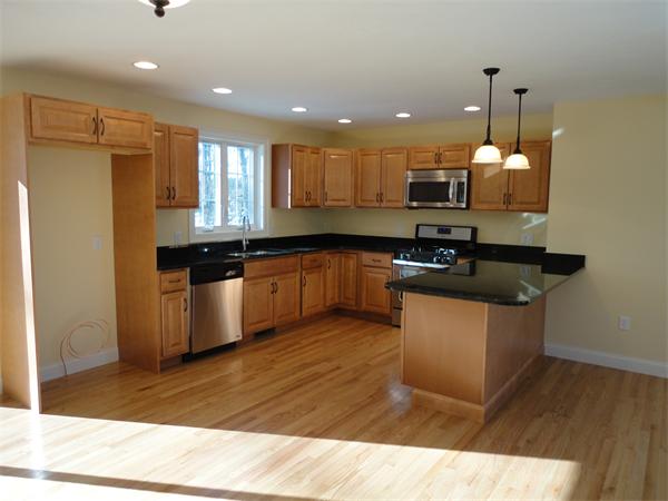 Lot 60 Hemlock West Roxbury, MA 02132 - Photo 3 of 9 a kitchen with kitchen island a sink stainless steel appliances and cabinets