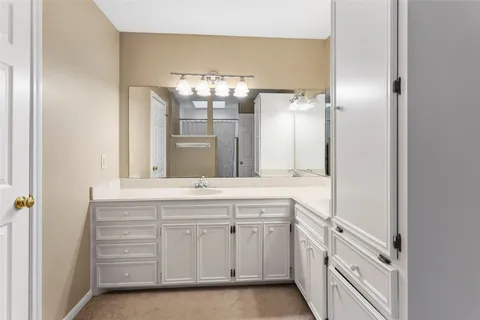 a spacious bathroom with a double vanity sink and a mirror