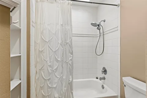 a bathroom with a shower curtain and a bathtub