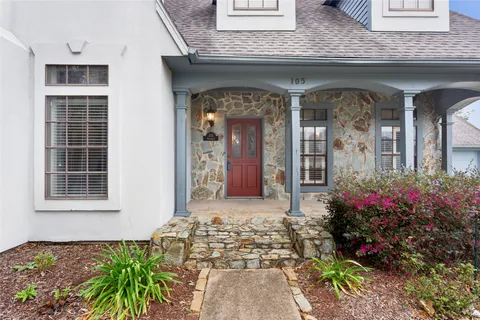 a front view of a house with a garden