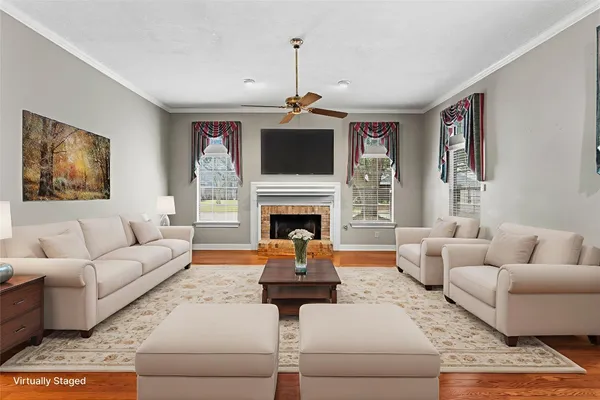a living room with furniture a fireplace and a flat screen tv