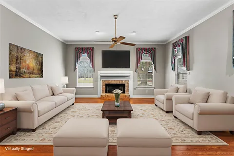 a living room with furniture fireplace and flat screen tv