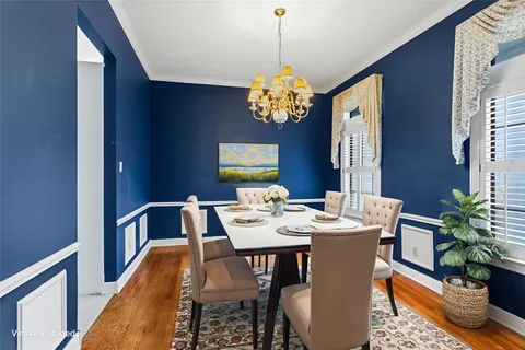 a view of a dining room with a table and chairs