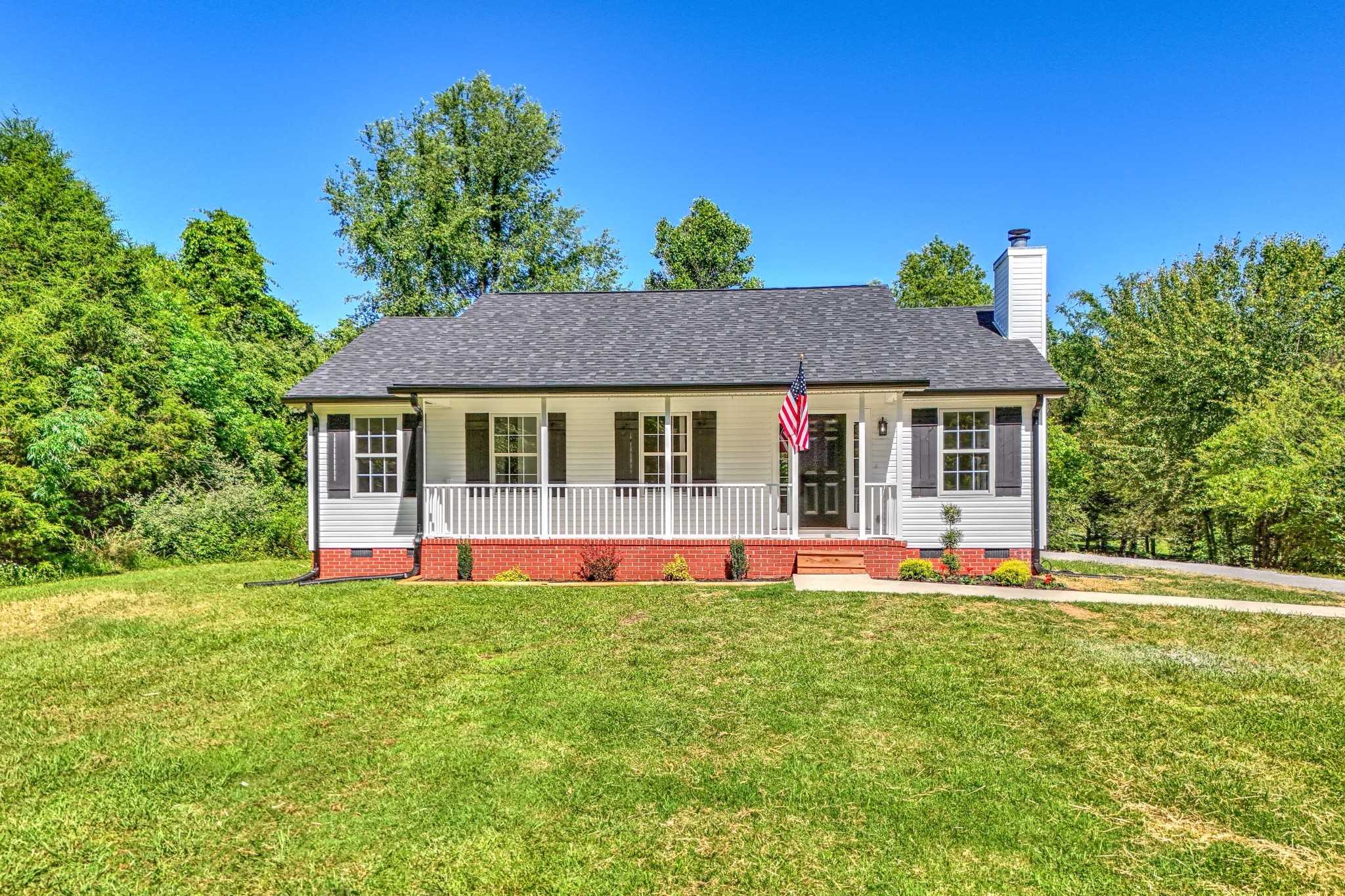 a front view of house with yard and green space
