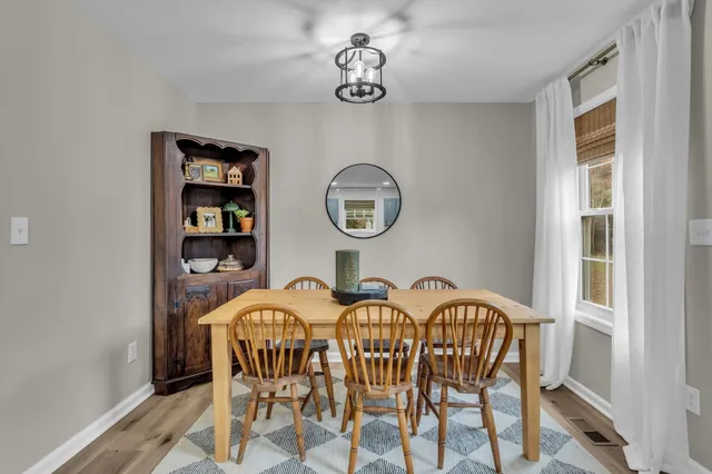 a view of a dining room with furniture and a window