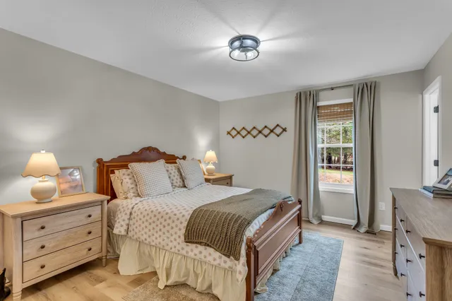 a bedroom with a bed and a lamp with window