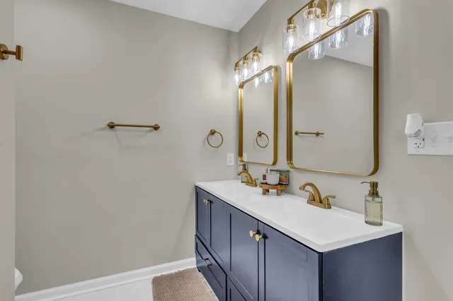 a bathroom with a sink mirror and vanity