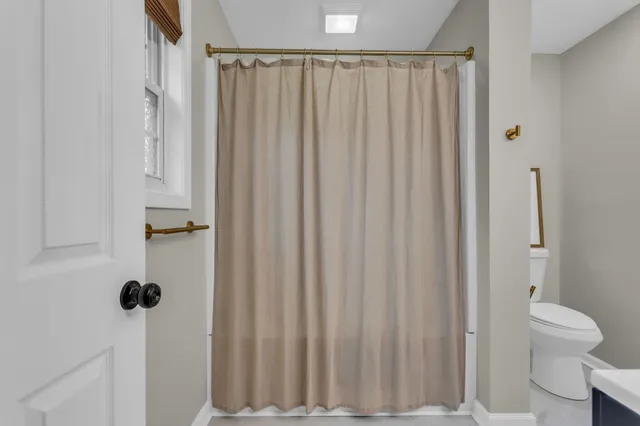 a view of a bathroom with a shower curtain