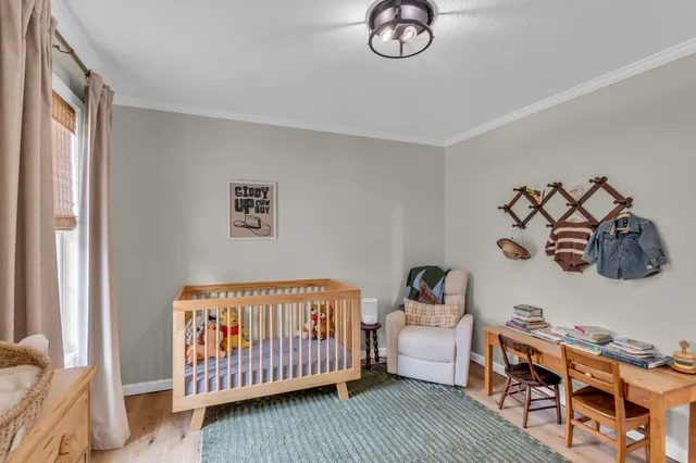 a bedroom with furniture and a window