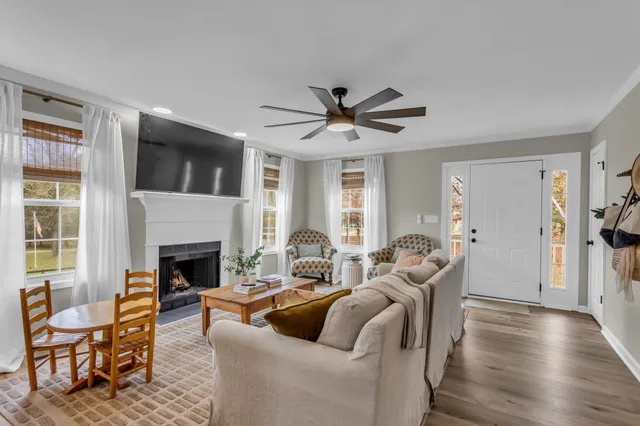a living room with furniture and a fireplace