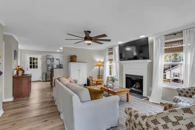 a living room with furniture a flat screen tv and a fireplace