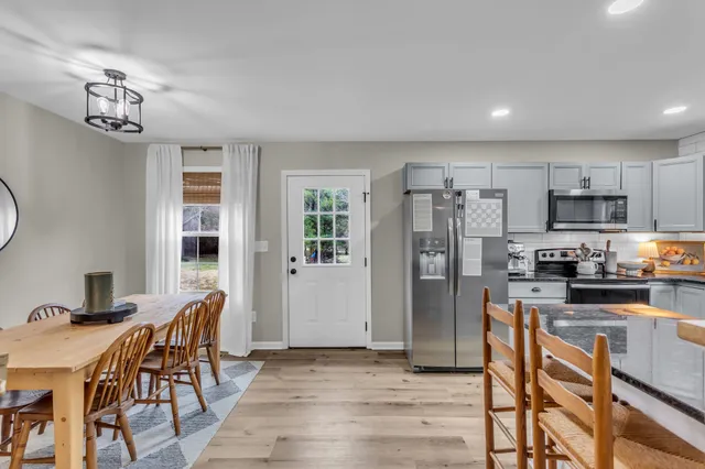a view of a dining room with furniture window and wooden floor