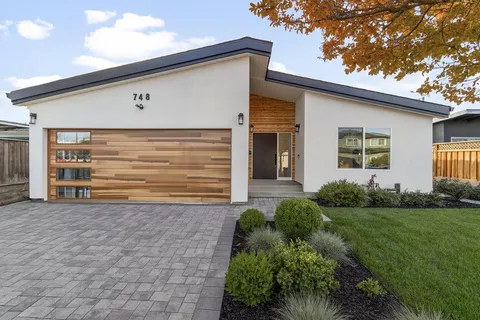 a front view of house with yard and green space