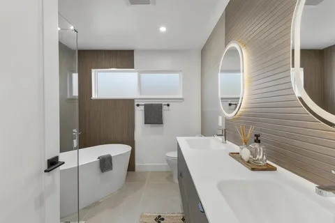 a bathroom with a sink a toilet and mirror