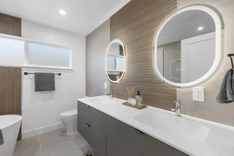 a bathroom with 2 sink and a mirror
