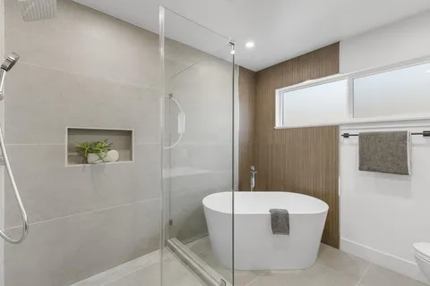 a bathroom with a bathtub and shower