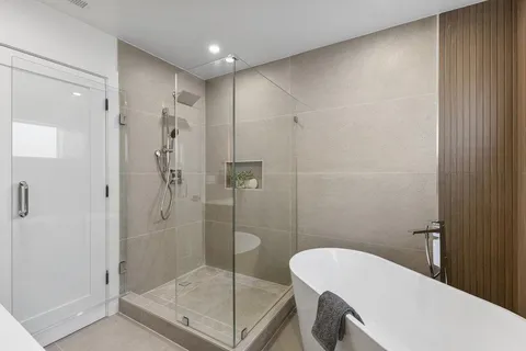 a bathroom with a shower a toilet and a sink