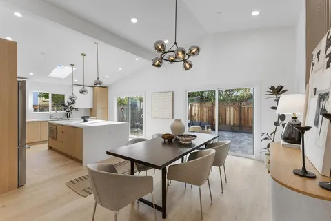 a view of a dining room with furniture and a chandelier