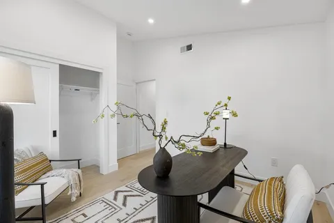 a dining room with furniture and wooden floor
