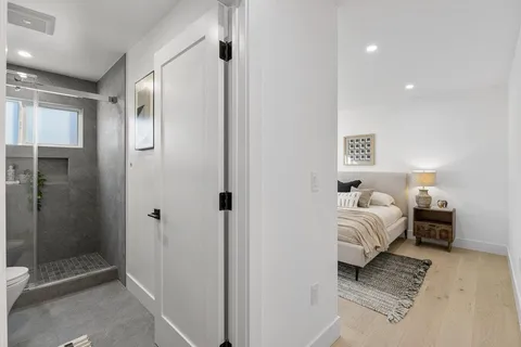 a spacious bedroom with a bed and a shower