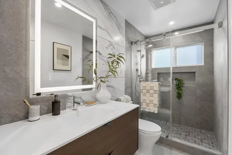 a bathroom with a sink toilet and shower