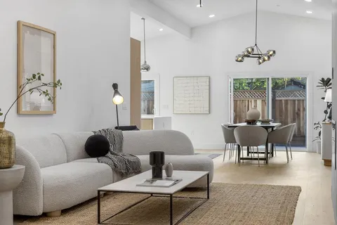 a living room with furniture a window and a chandelier