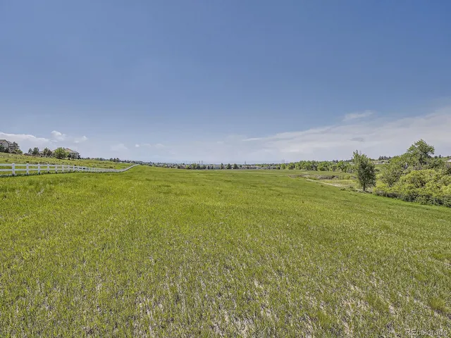 a view of a big yard with table and chairs